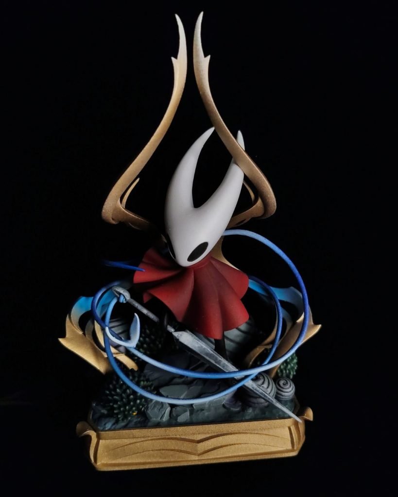 Hand-painted statue inspired by Hornet from Hollow Knight: Silksong, with her needle and blue silk thread, on a golden base