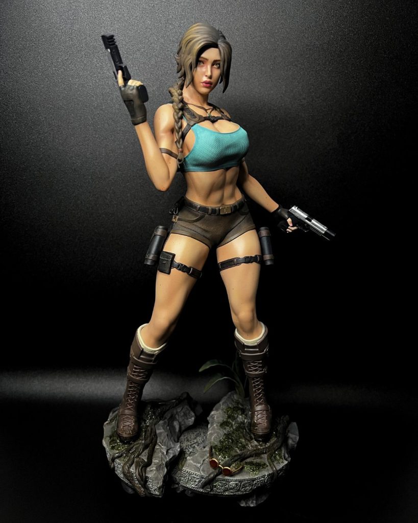 Hand-painted statue inspired by Lara Croft, holding two pistols on a jungle rock base with roots and moss