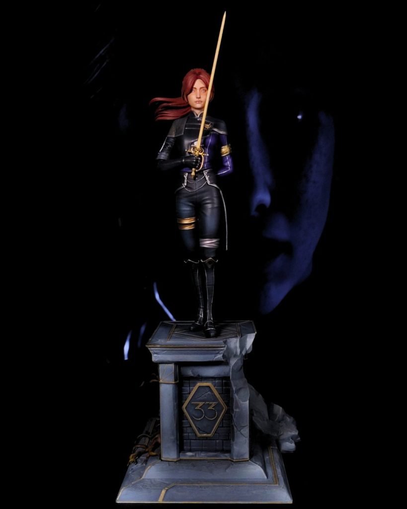 Hand-painted statue inspired by Maelle from Clair Obscur: Expedition 33, holding a golden rapier on a stone pedestal with the 33 emblem